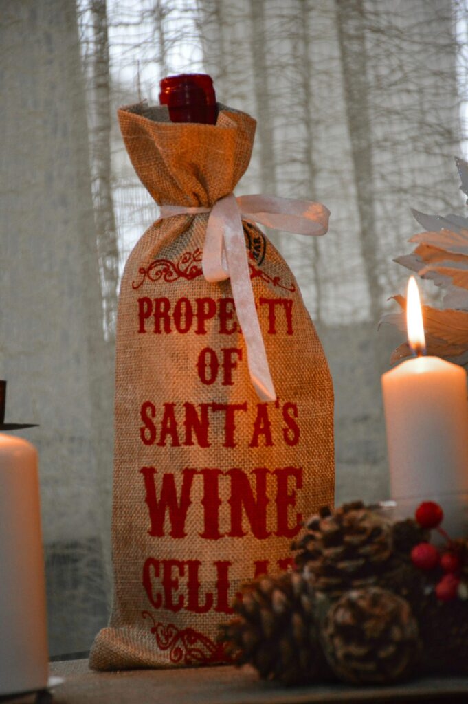 wine bottle in a burlap christmas gift bag
