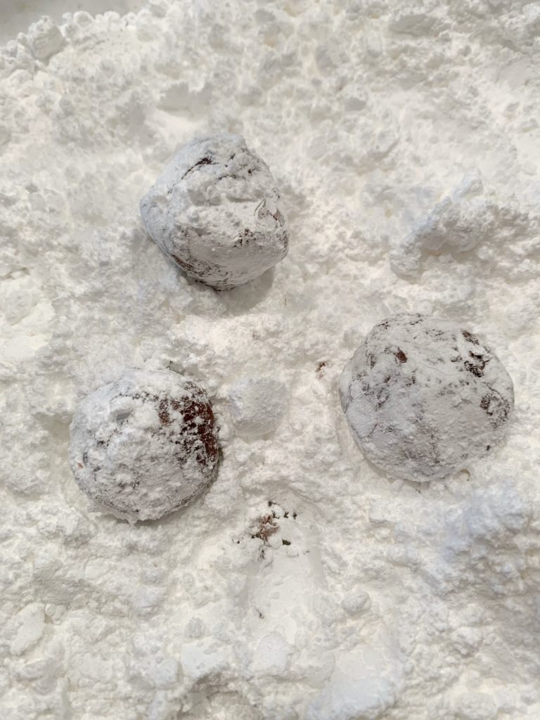 unbaked cookies in powdered sugar