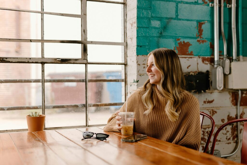woman sitting alone in a coffee shop a benefit of self-love