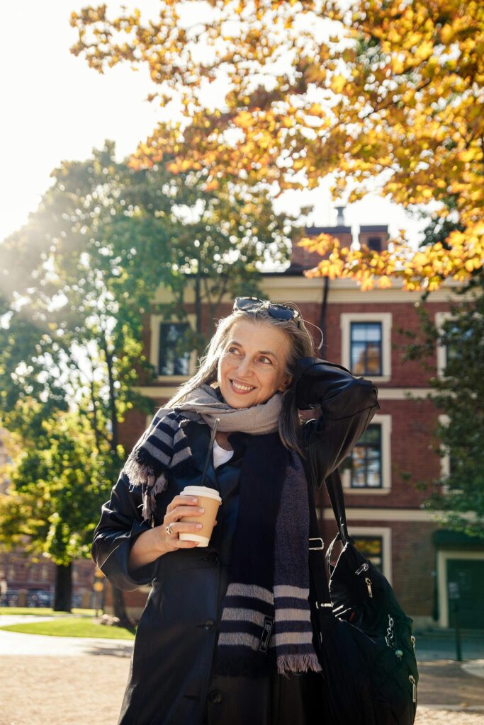 Midlife woman walking outdoors, reflecting on the importance of self-love during life transitions.