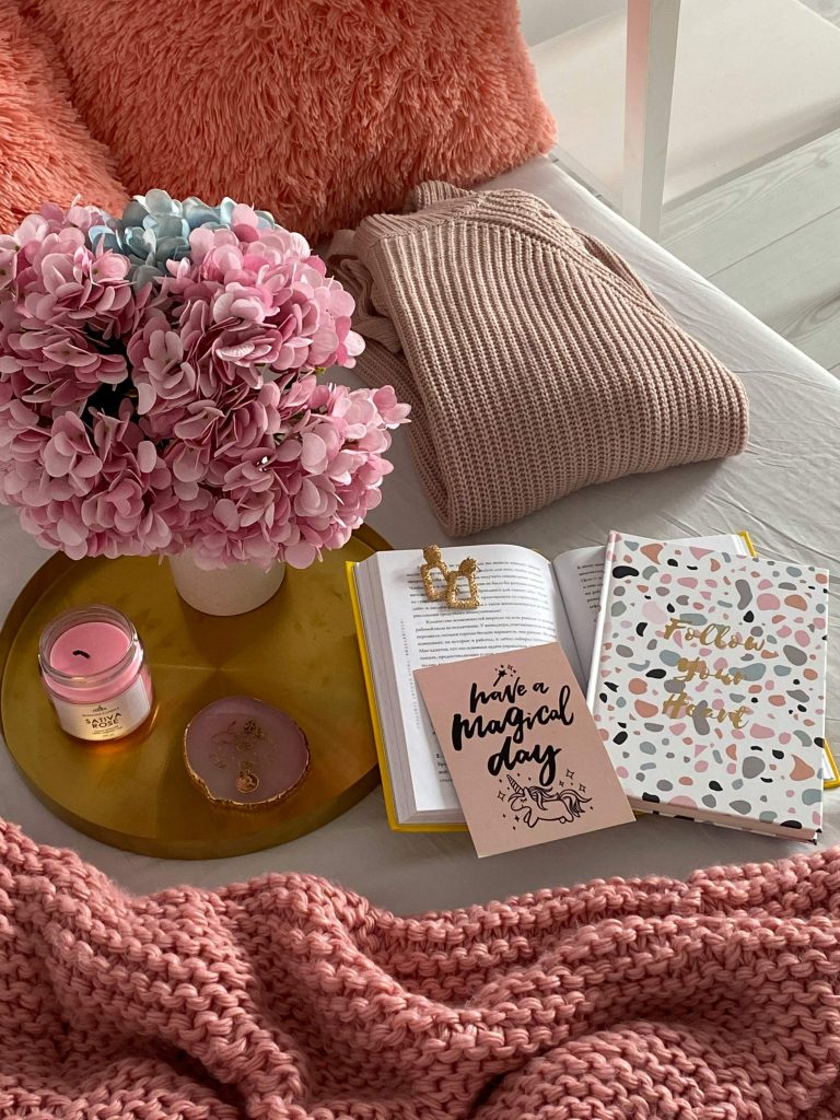 diy self-care basket ideas including a candle, journal, and blanket