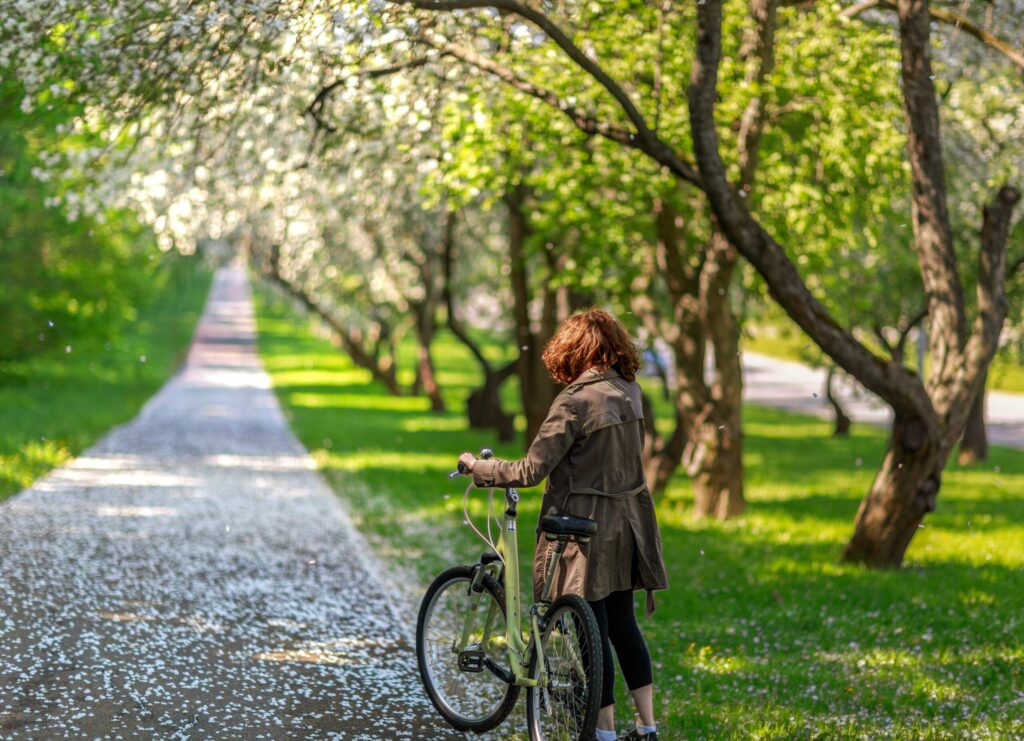 Midlife woman enjoying a spring bike ride outdoors