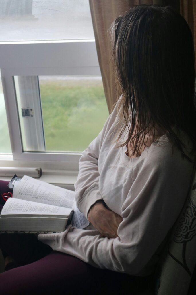 A woman with a book aking time to decompress and reset her mind as part of mental spring cleaning tips
