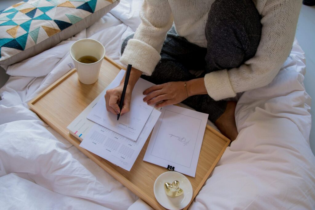 woman writing down her toughts as a mental spring cleaning tip to brain dump