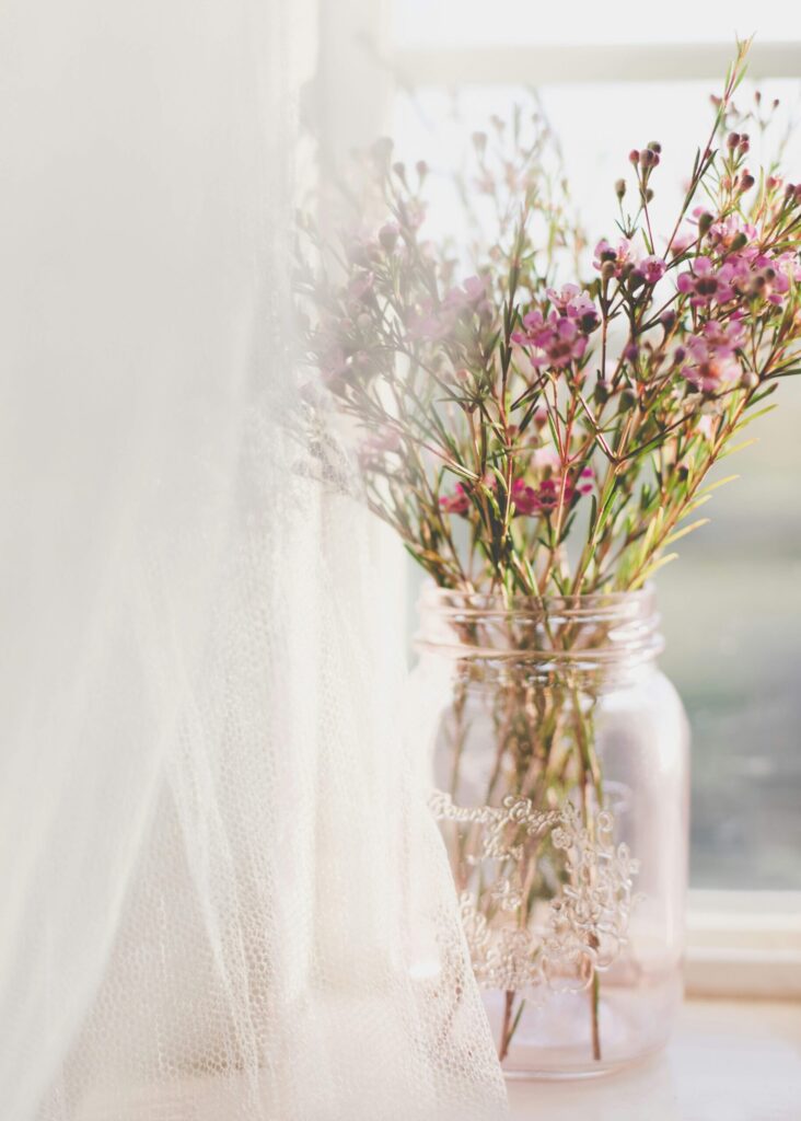 spring flowers in a vase by a window as a reminder of renewal for mindset