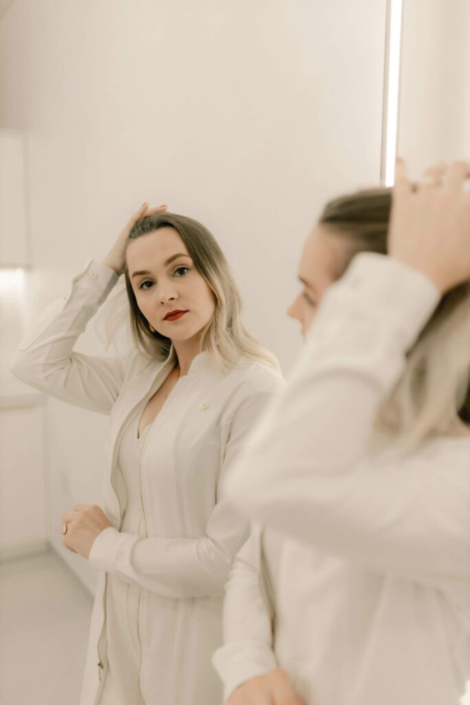 woman looking in the mirror with a positive body image