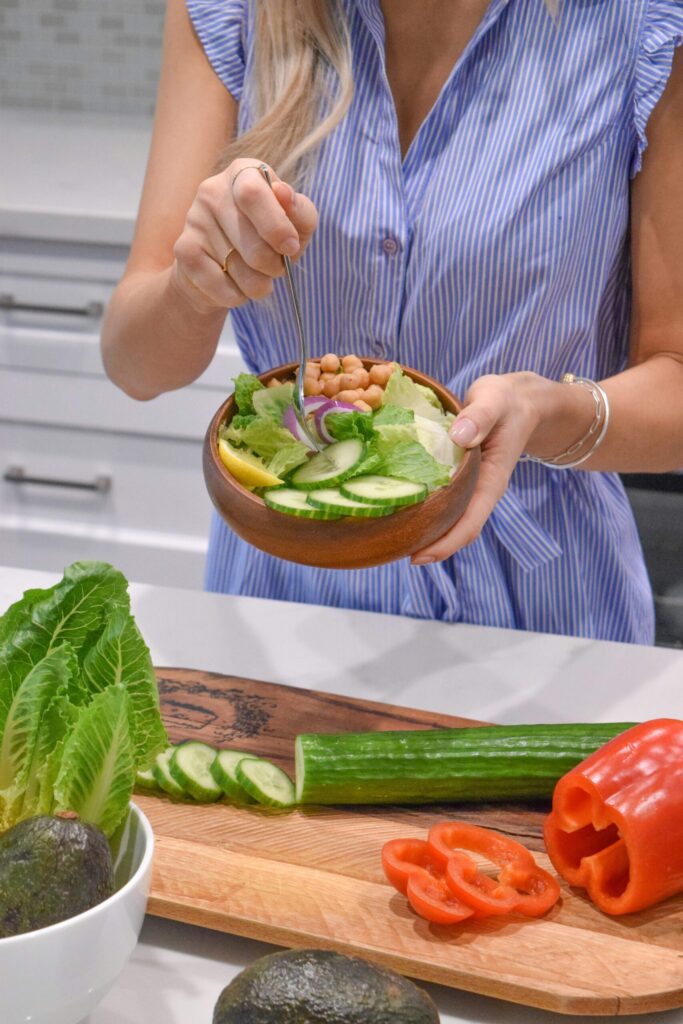 woman preparing a salad. health is a common cause of stress in women
