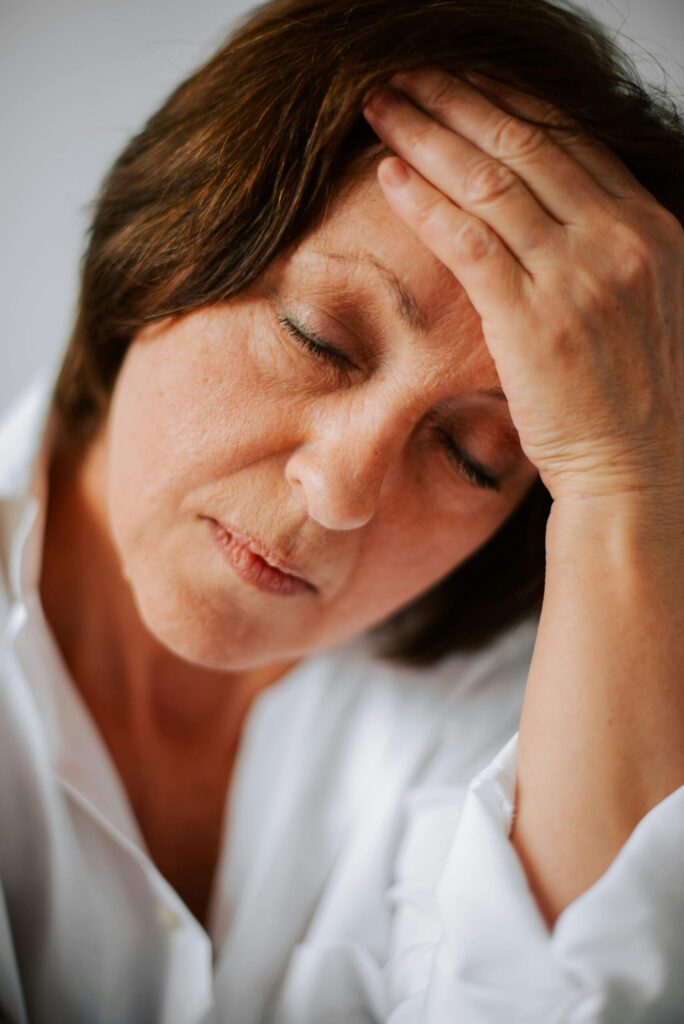 woman looking fatigued or stressed. common causes of stress in women