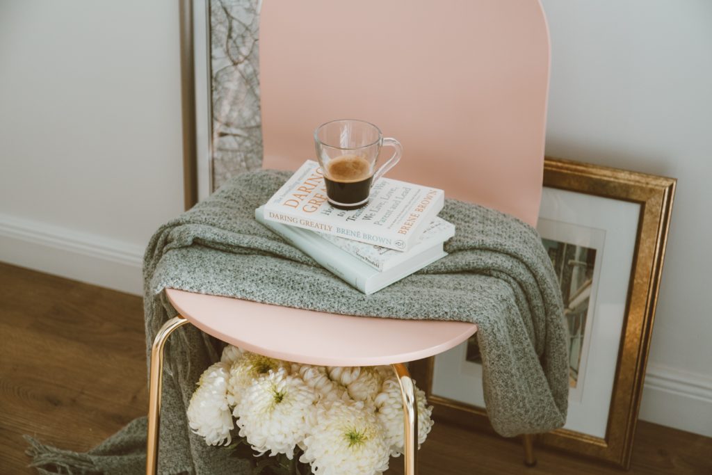 Chair with cup of coffee and books