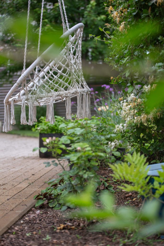 swing in a backyard to relax in as a summer activity for adults