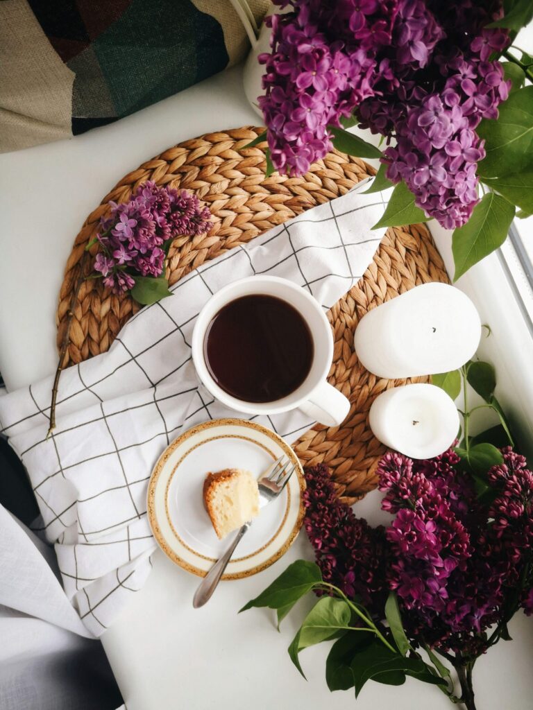 cup of coffee, flowers and a sweet treat for self-care to help manage the challenges of balancing work and family