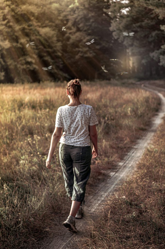 woman walking outdoors to support healthy habits and wellness