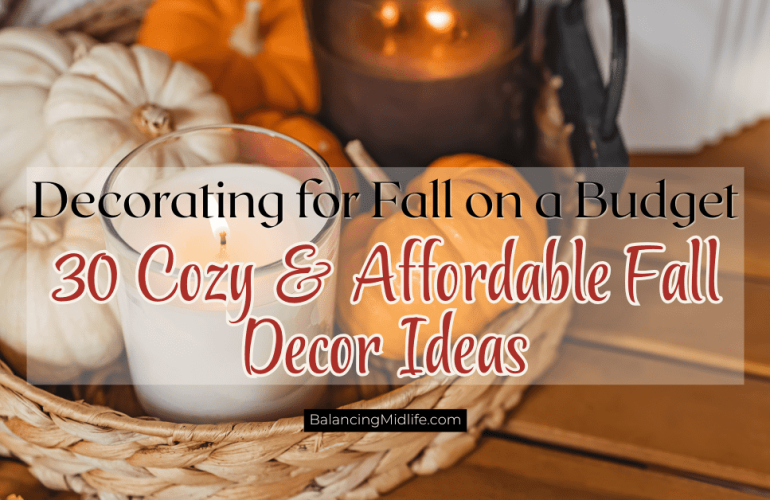 Cozy living room decorated for fall on a budget with pumpkins, throw blankets, candles, and neutral autumn decor.