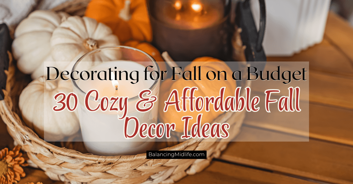 Cozy living room decorated for fall on a budget with pumpkins, throw blankets, candles, and neutral autumn decor.