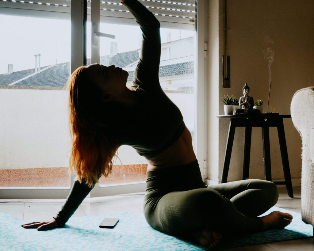 woman practicing yoga as self-care