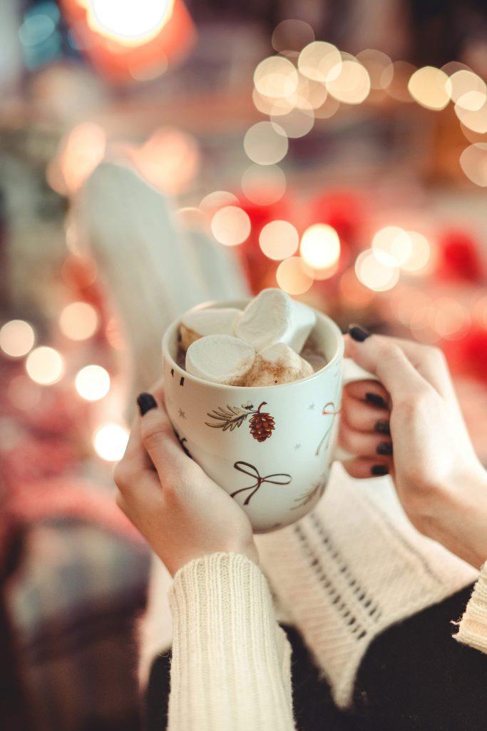 Woman enjoying a quiet Christmas morning at home with a cup of coffee