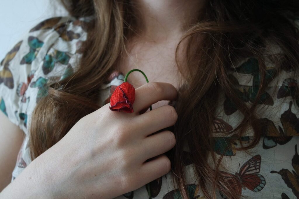 self-love benefits, woman holding wilted rose