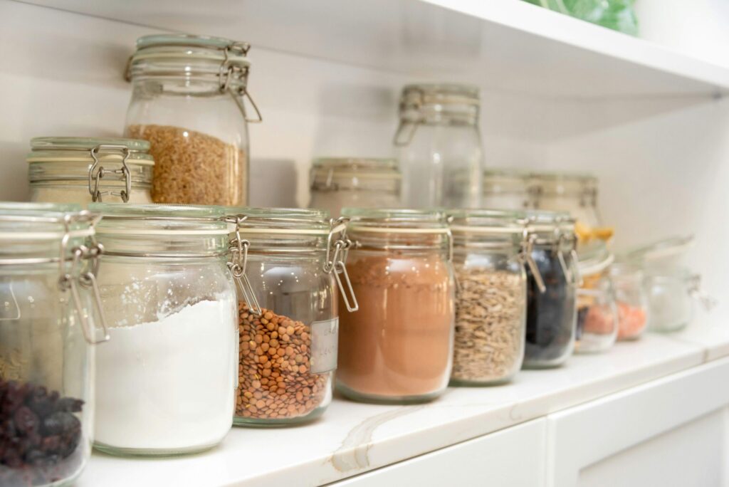 glass jars filled with dry food items organized nicely for self-care