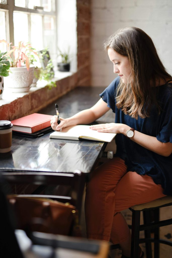 Woman journaling quietly in a peaceful home setting to support mental clarity and mindfulness