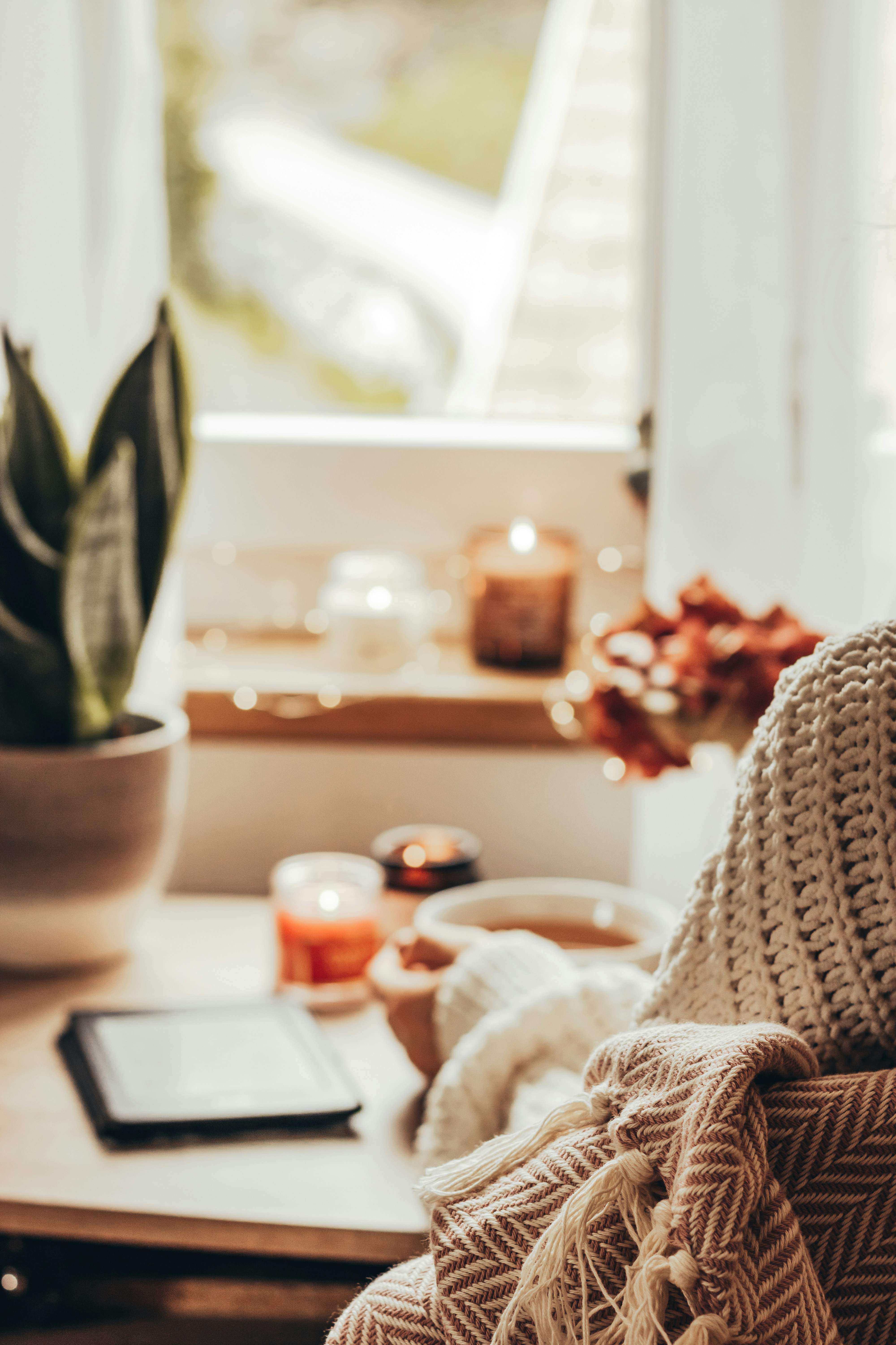 Cozy fall journaling setup with notebook, tea, and autumn decorations for mindful reflection.
