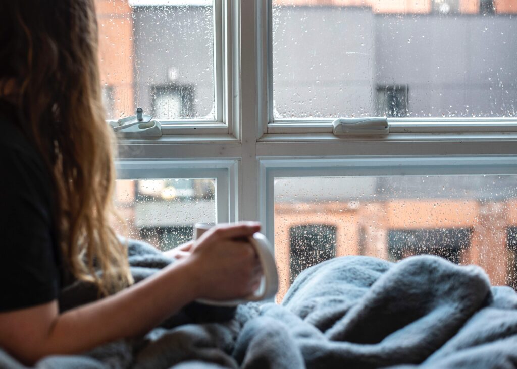 woman looking out window