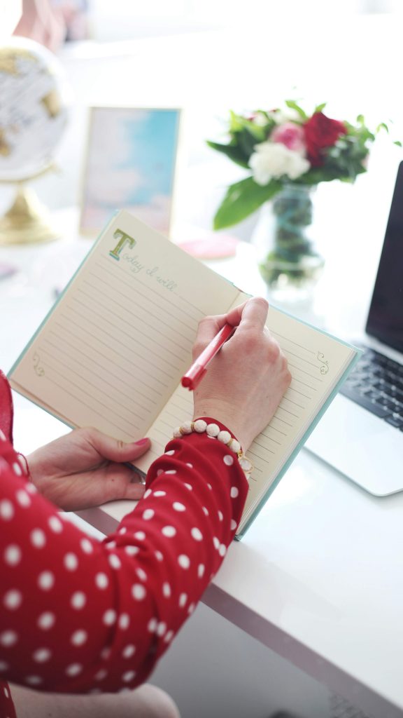 Woman reviewing her planner and setting boundaries during the holiday season