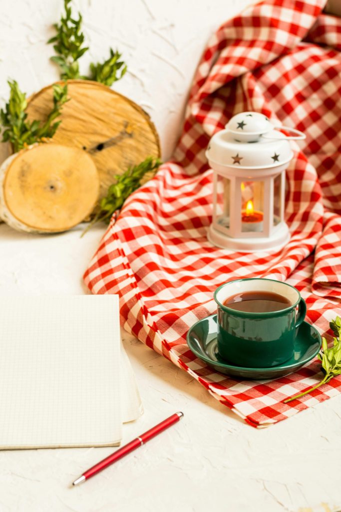 Simple holiday planning list with coffee and seasonal greenery
