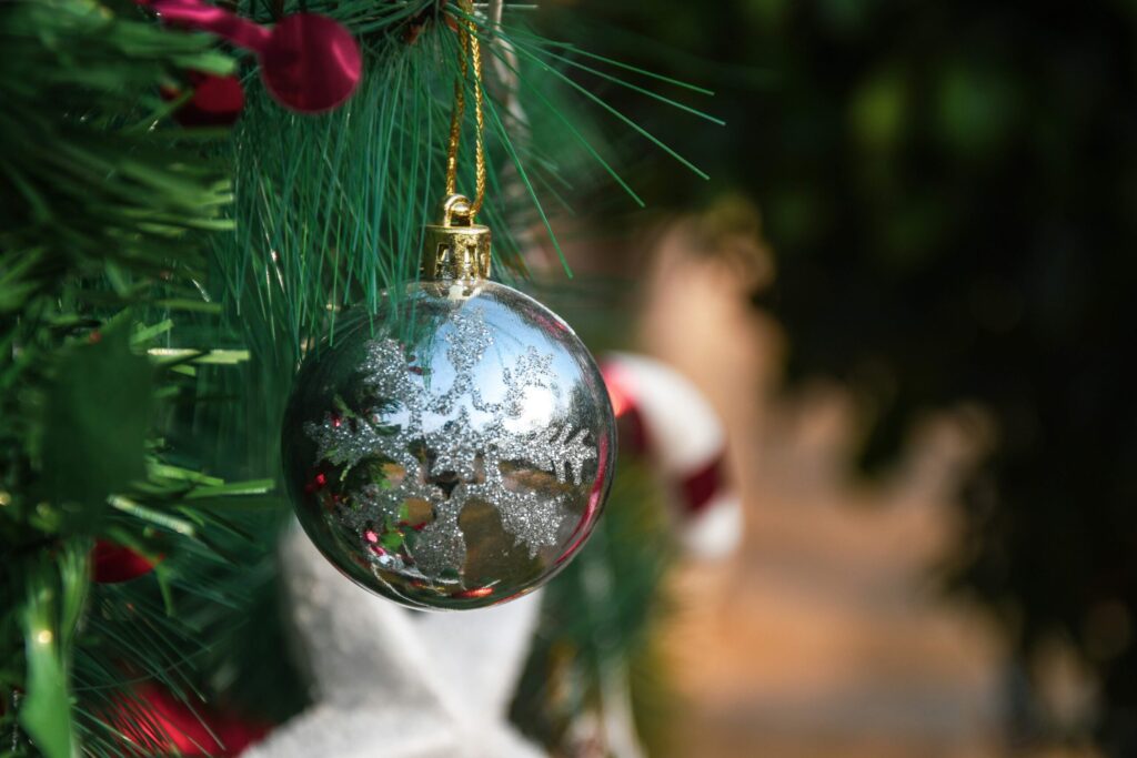 Close-up of a metallic ornament on a rustic-style Christmas tree