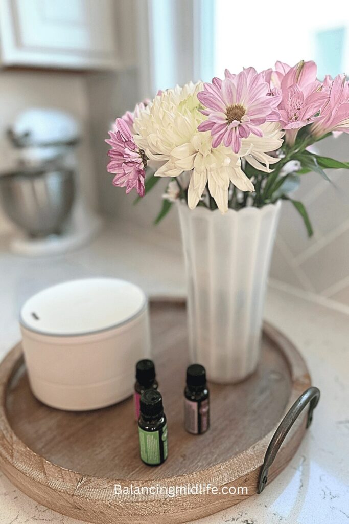 Home essentials for midlife women with flowers, diffuser, and essential oils