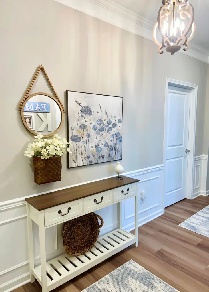 Organized entryway table with seasonal wall decor, showcasing cozy home and simple organization ideas.