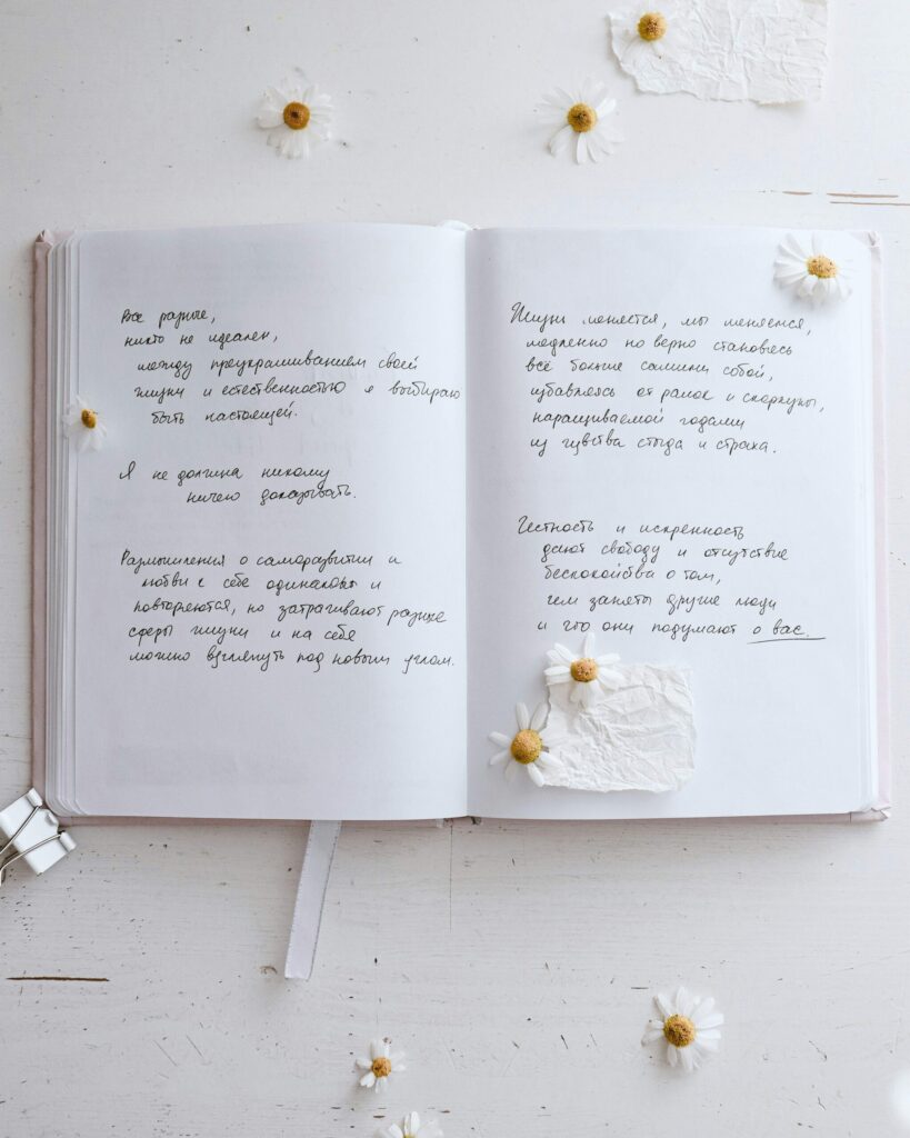 open journal with writing and spring flowers.