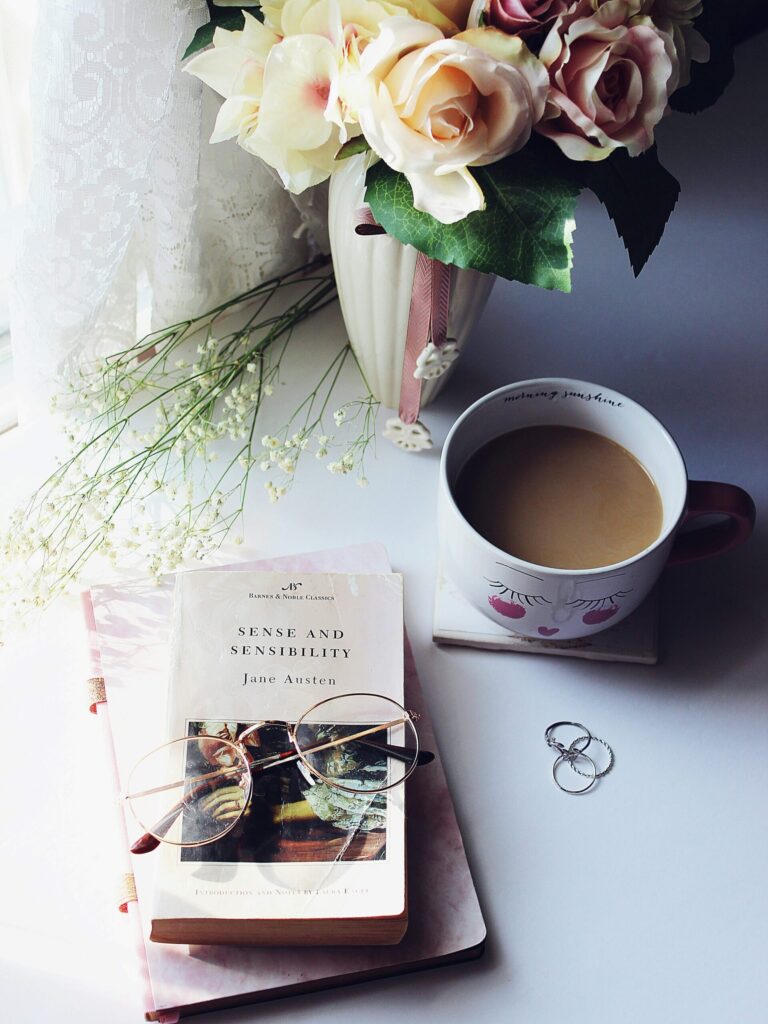 journal/books, flowers and a cup of coffee. spring journal prompts for midlife women