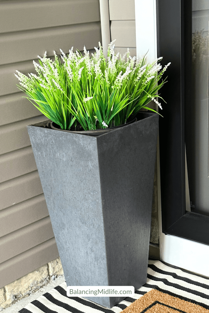 faux greenery in planter for a cozy corner in summer front porch decor