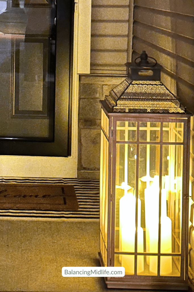 candles lit inside lantern by front door