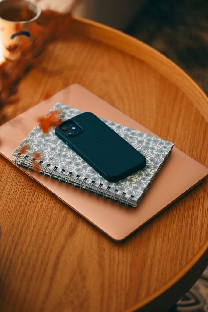 Phone set aside on a book as part of simplifying digital life and reducing distractions. A recommendation from the simplify your life checklist